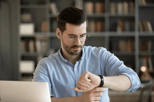 A man checking the time on his wrist watch