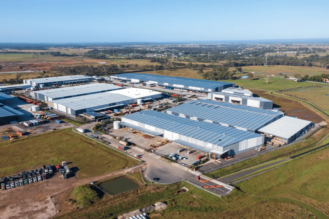 Drone aerial photgraph of large buildings located in a green field in an industrial complex in Australia