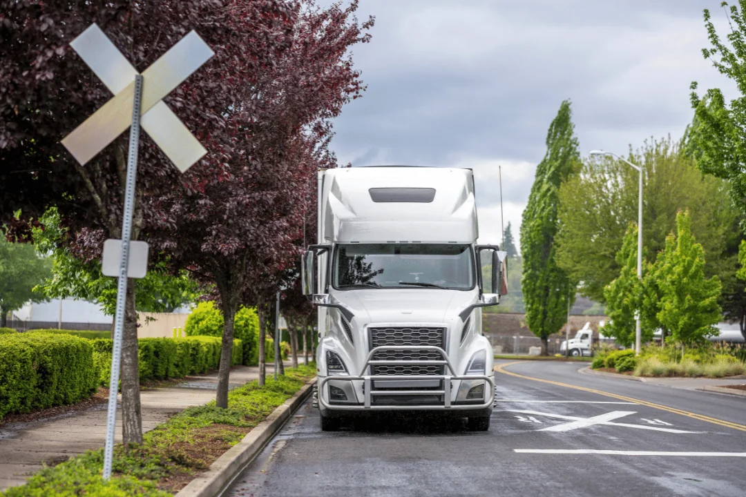 What you can do to avoid missed pickups White Semi Trailer Stopped At A Railroad Crossing Sign