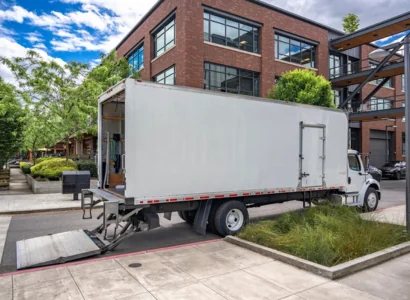 semi truck with box trailer for local freights standing with open back door on the urban city street