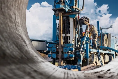 two men preparing large machine