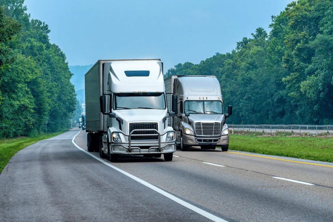 What Trends Will Shape Holiday Shipping white and gray semi traielrs driving down highway on a clear summer day