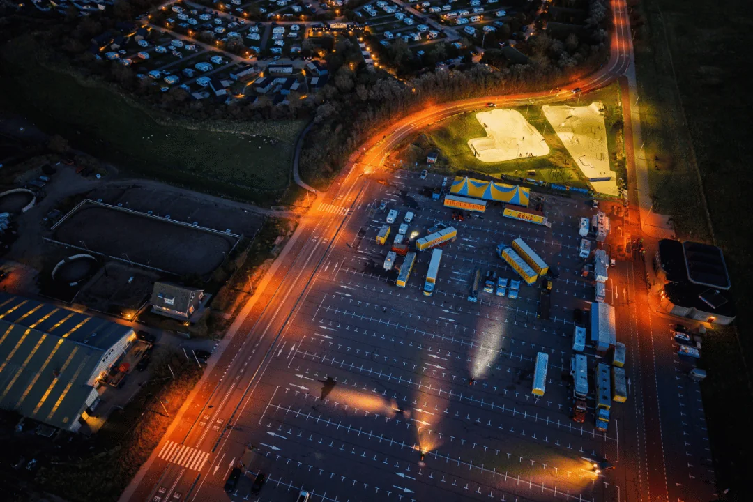 Freight Shipping Circuses aerial view of a modern big top circus set up in a parking lot at night