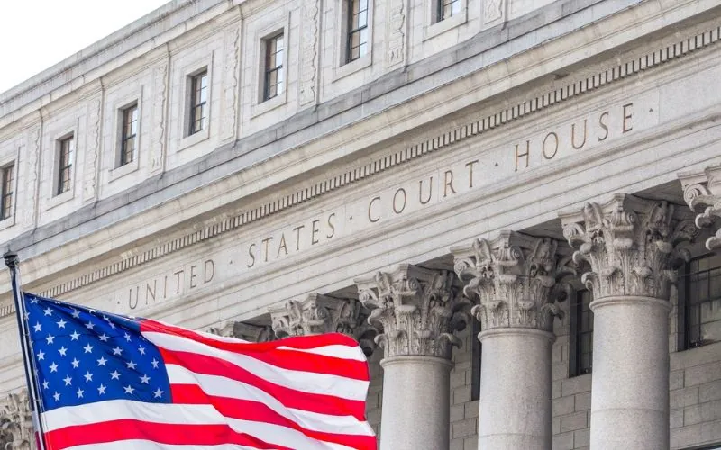 USA national flag waving in the wind in front of United States Court House in New York