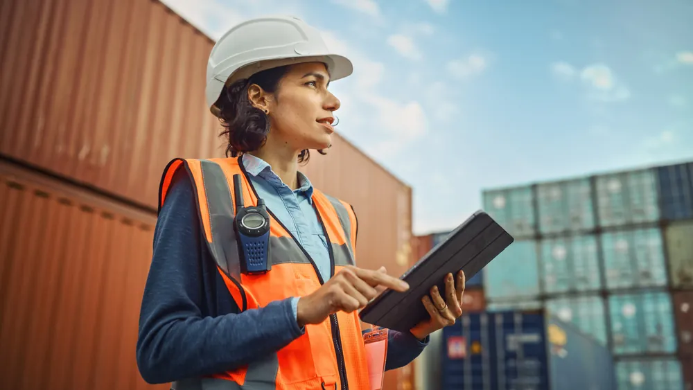 lady working at a dock near containers