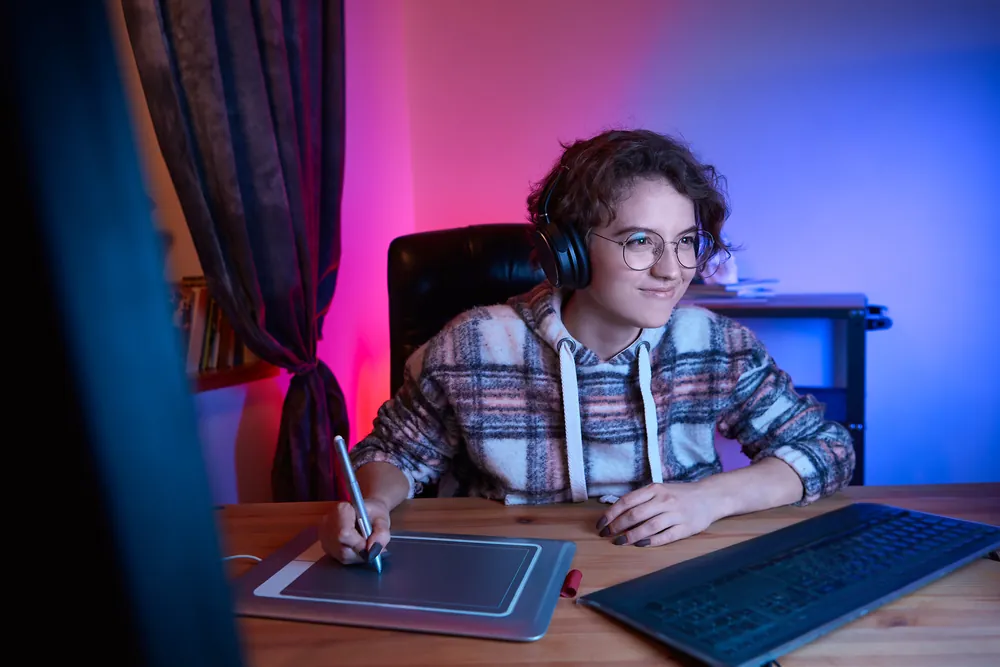 Toy Freight 101 person working at a desk with drawing tablet