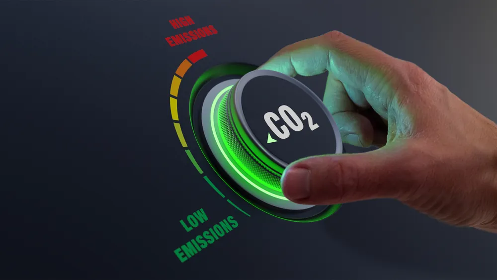 Sustainability Goals for 2026 hand turning knob labeled CO2 to the low emissions setting