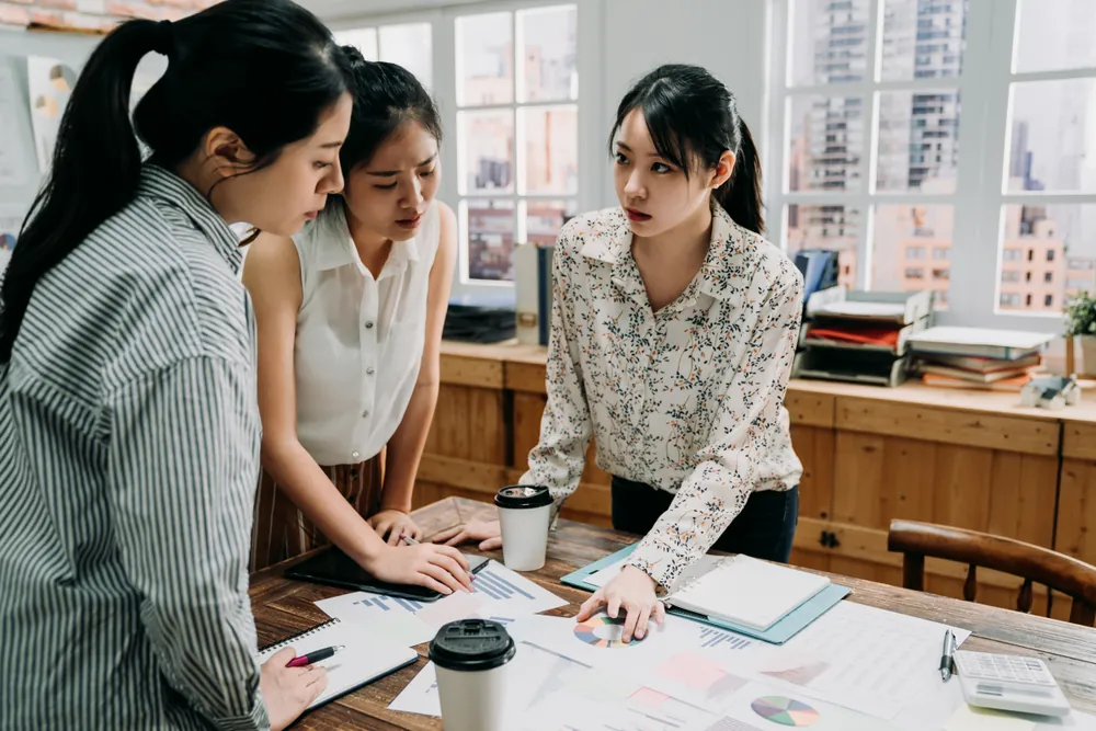 The Quiet Season business women looking at data