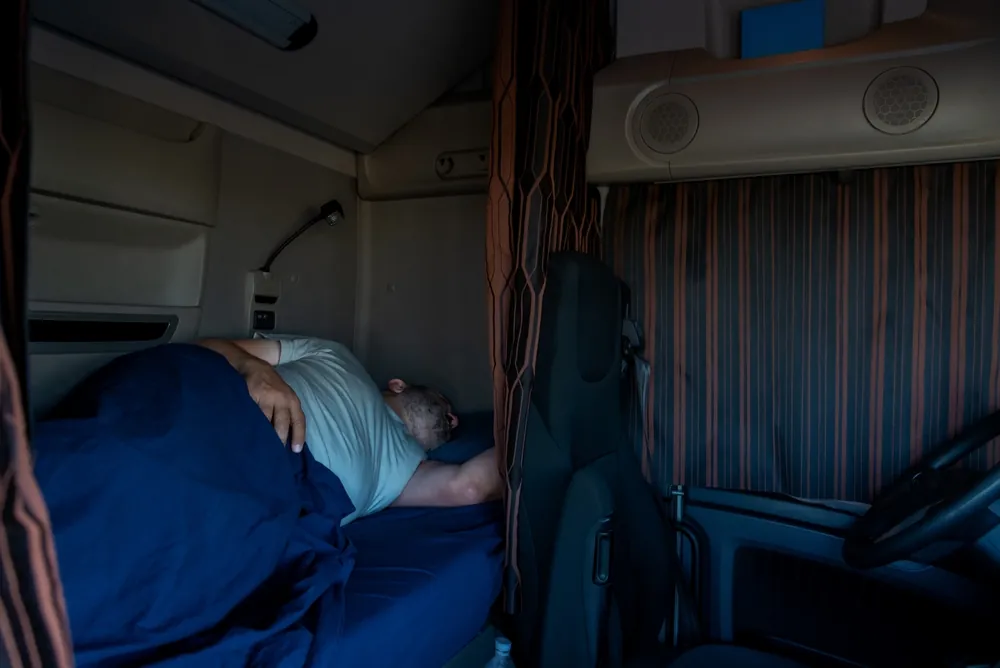 trucker resting in sleeper berth