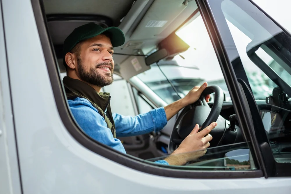 Trucker Tips For Healthier Living happy trucker at the wheel
