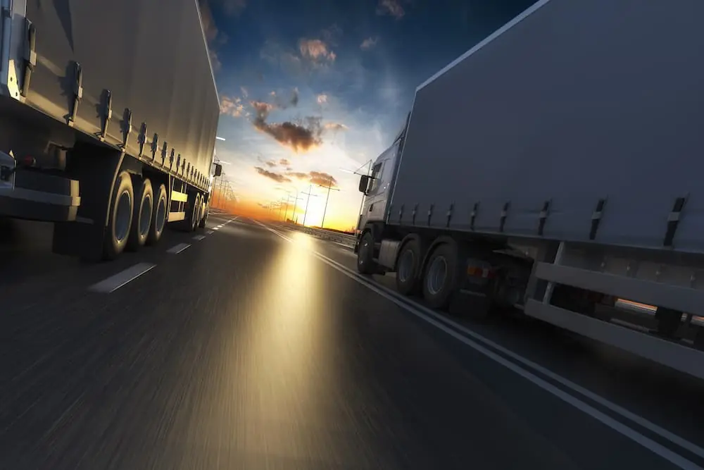 The Climate Forces Reshaping Freight in 2026 two trucks passing each other on the highway