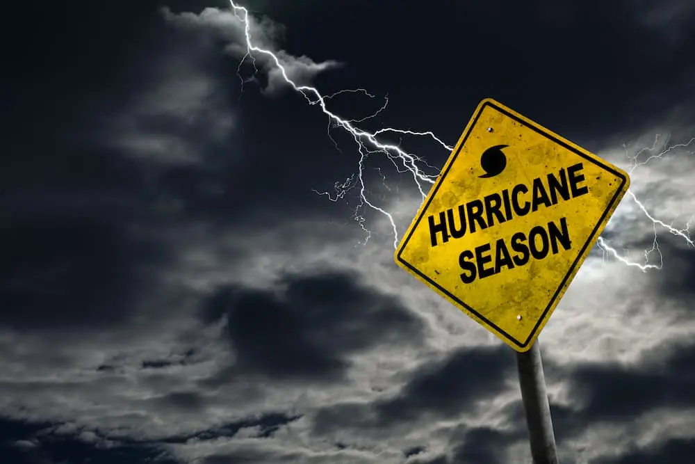 The Climate Forces Reshaping Freight in 2026 yellow road sign says Hurricane Season holding firm against heavy storm