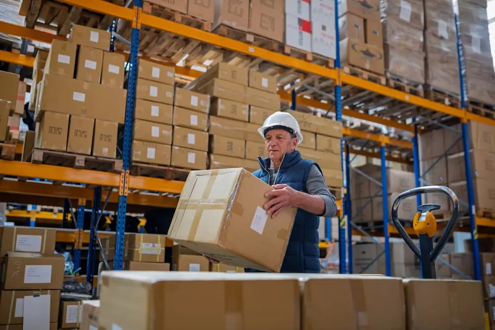 The Rise and Fight Against Chameleon Carriers warehouse workers stacking boxes to create pallet