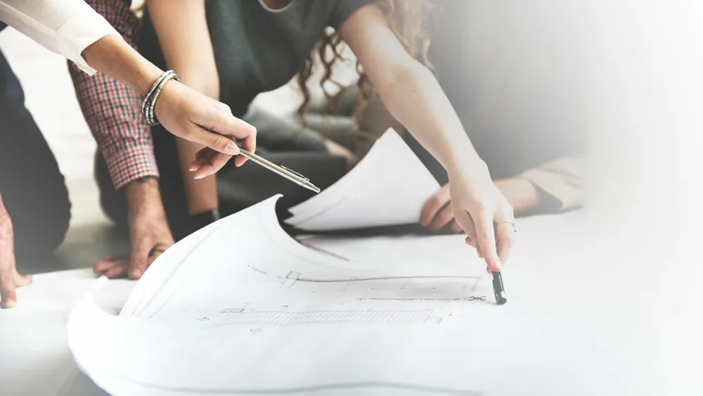 people looking over convention floor plans