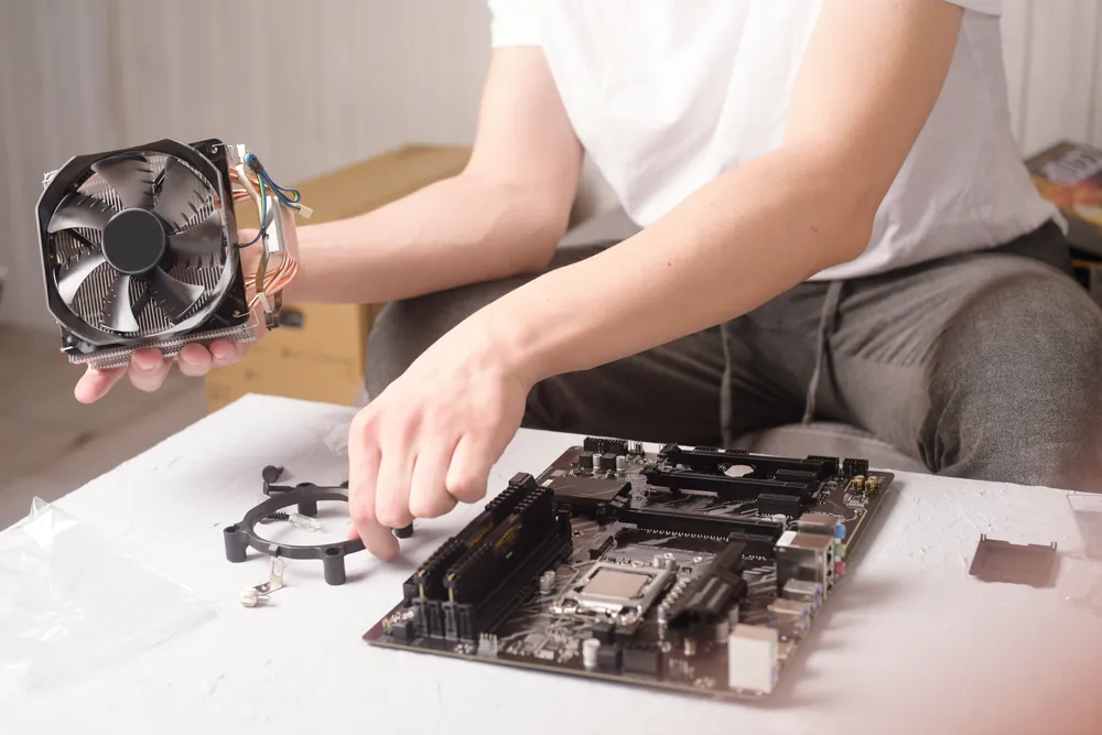 person working on computer fan
