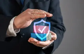 Protecting Your Freight with Insurance businessman holding a hologram of a symbol of freight insurance in his hands