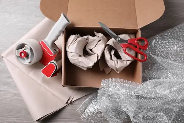 cardboard box being prepared for shipping
