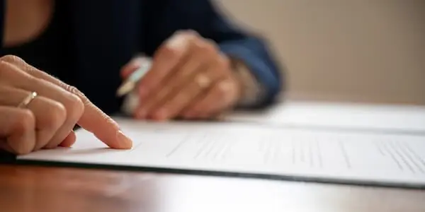 Protecting Your Freight with Insurance person reviewing policies on desk