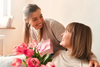 Mother’s Day Gift RESIZ daughter with mom giving gifts for mothers day