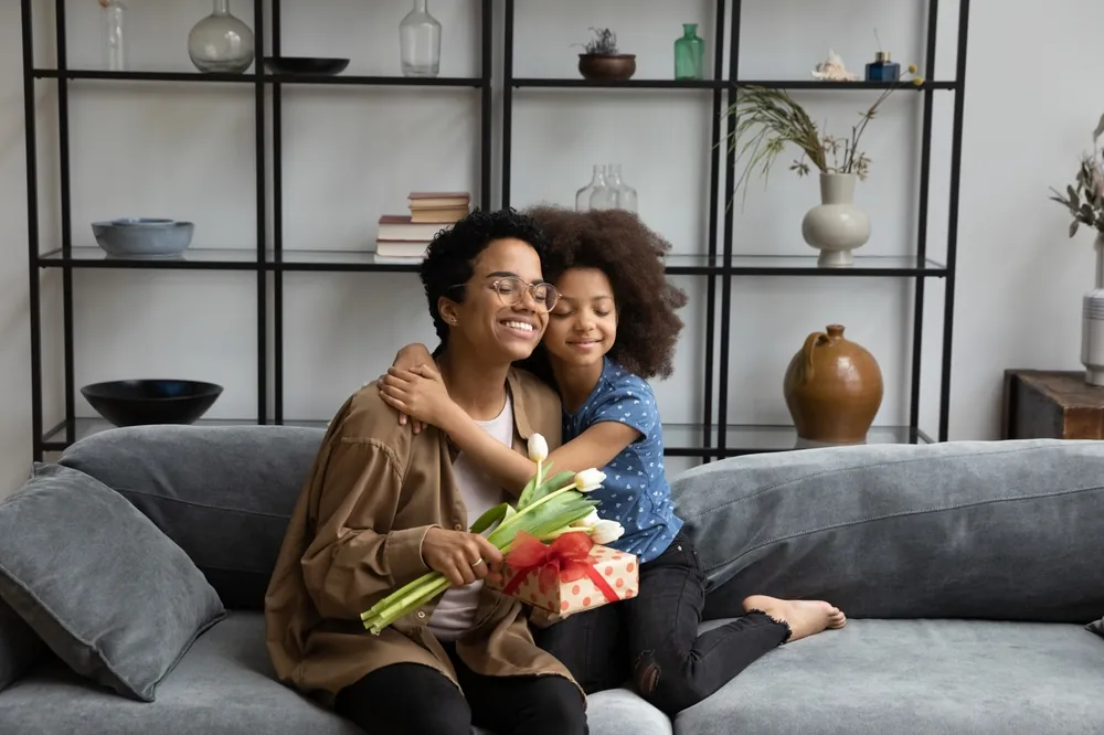 mom and kid hugging and getting gifts
