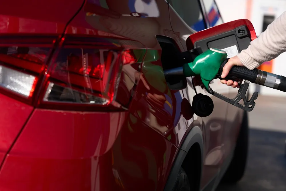 person pumping gas into car