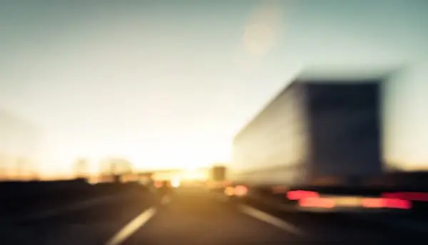 Try Before You Buy semi trailer speeding down highway at dawn