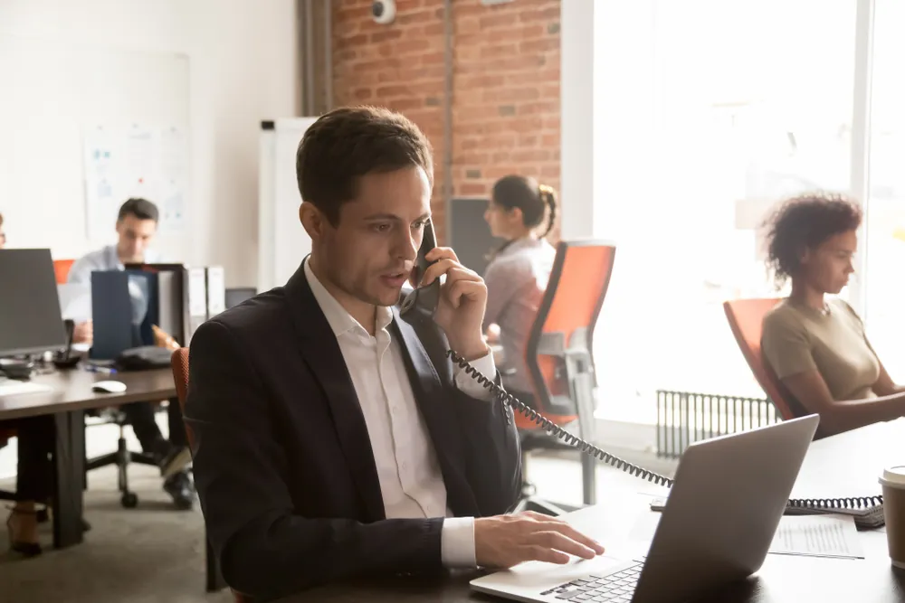 man talking on the phone with laptop
