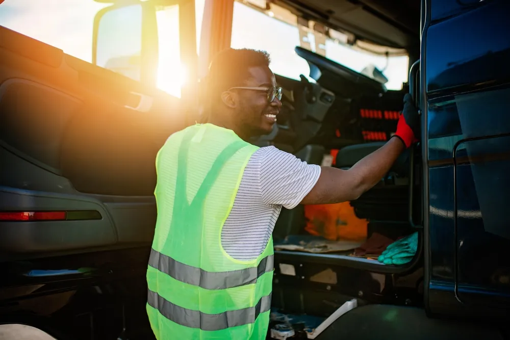 truck driver smiling getting into truck
