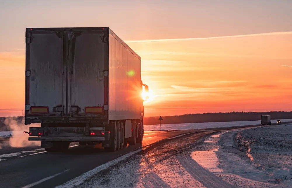 truck driving into the sunset