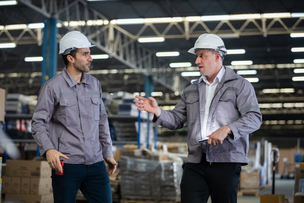 warehouse workers having discussion inside