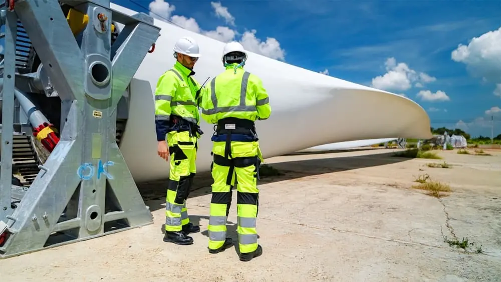 Clean Energy Logistics two workers discussing set up of wind turbine