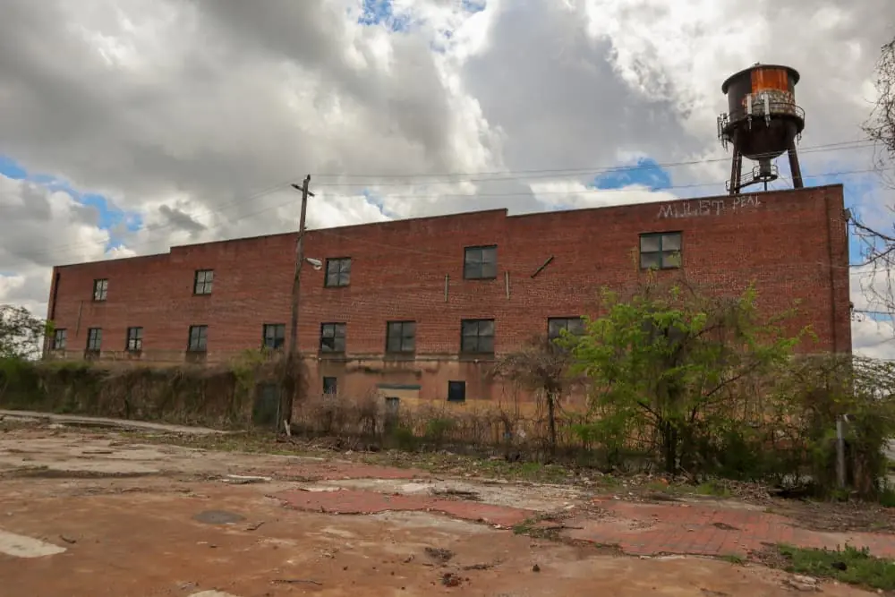 Harsh Reality of the Modern Freight Recession abandoned brick building next to an abandoned water tower