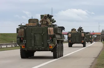 Military Logistics SM RESIZ military tank driving on road