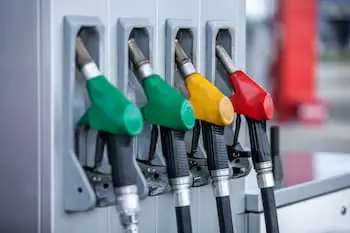 close up of multiple colored nozzles at a gas pump