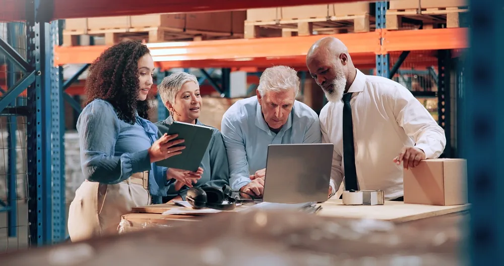 Yellow Corp Bankruptcy warehouse staff gathered around laptop on a desk as they discuss data
