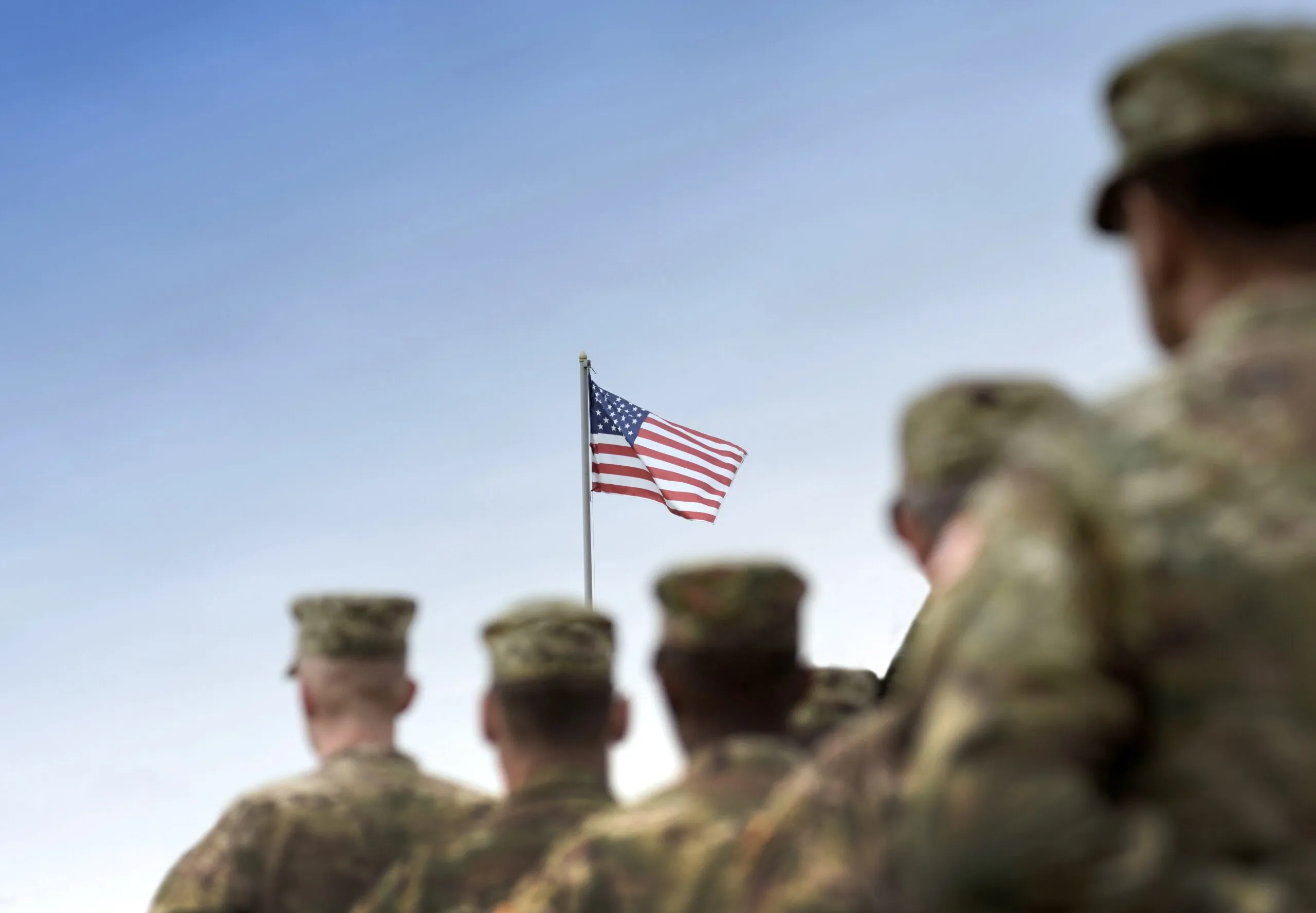 military members in line looking at american flag