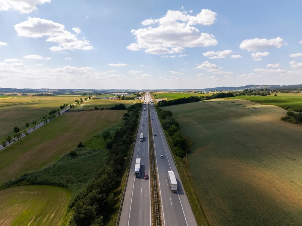 trucks driving on a rural road