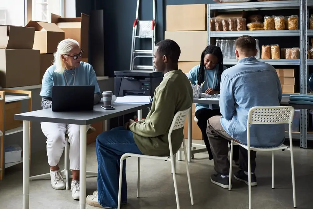 Freight Microhub business shipping team having a meeting inside a modern warehouse office