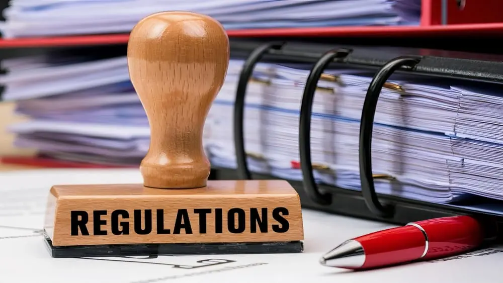 Three Rs of Network Design close up of a wooden stamper with the word regulations
