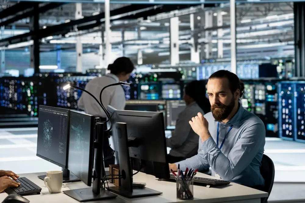 Three Rs of Network Design supply chain professionals working on computers analyzing data in a spacious office