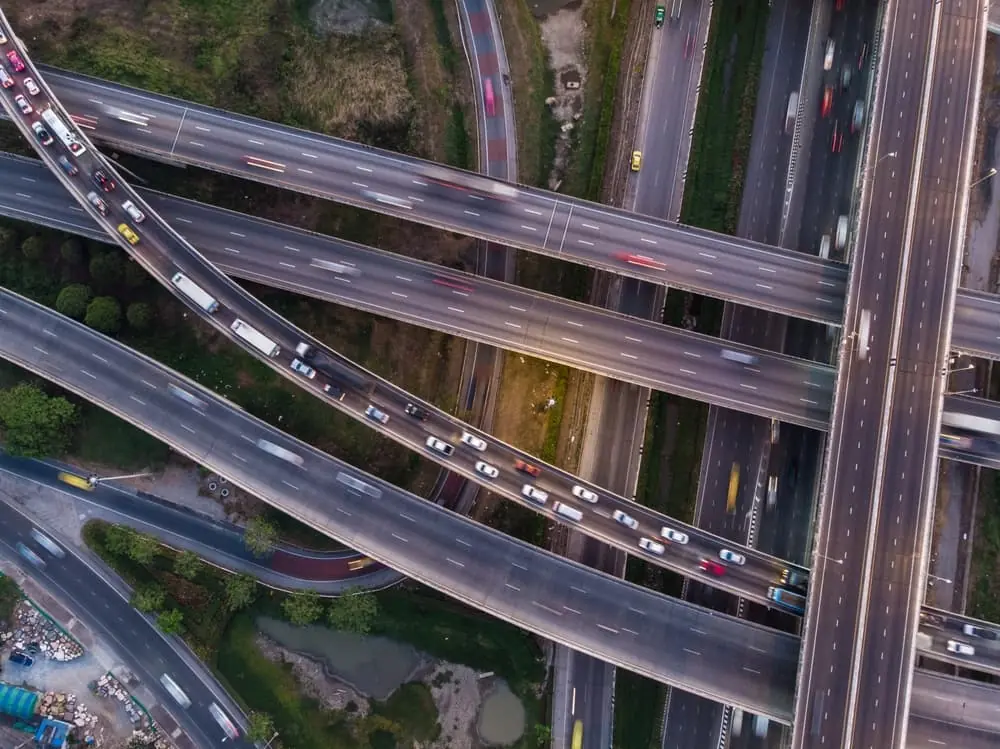 Truck Bottlenecks aerial view of complicated highway system during the evening rush hour