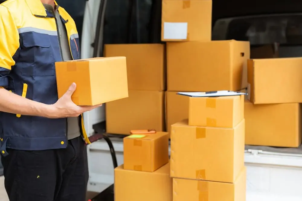 Truck Bottlenecks eCommerce delivery man stacking parcels to be delivered